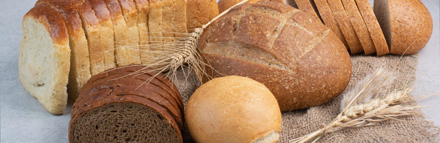 Various homemade bread on burlap with wheat. High quality photo